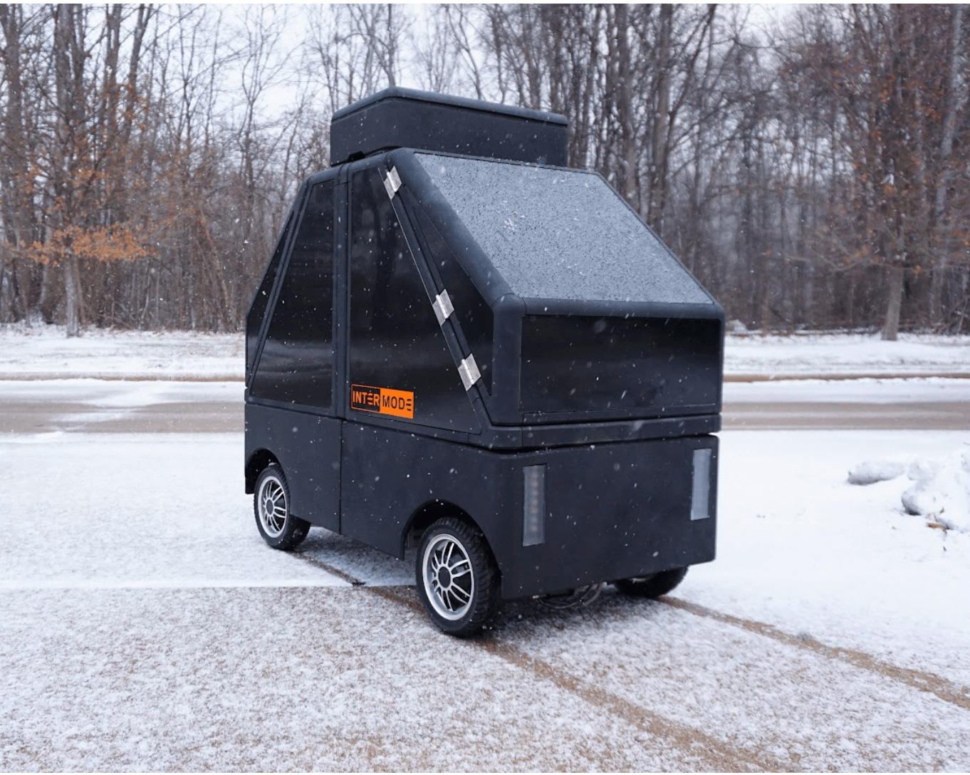 A large black intermode rover controlled with CANBUS protocol chilling outside in the snow.
