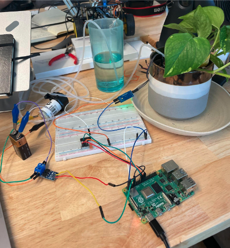 Picture of the plant watering robot on a desk.